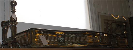 Georgian pierced brass fender, applied floral patera and a pair of ball finial fire dogs